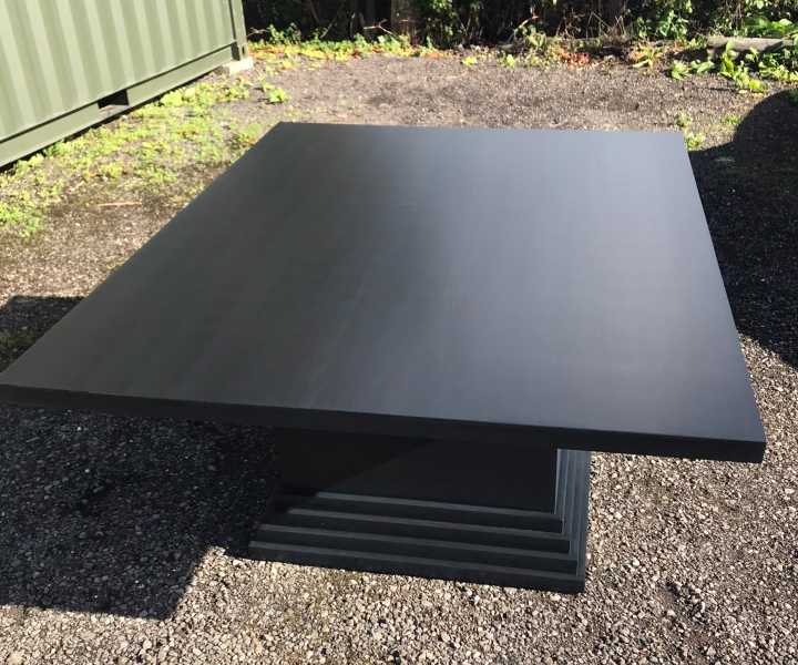 black-painted-dining-table-waits-delivery Black painted table waits delivery
