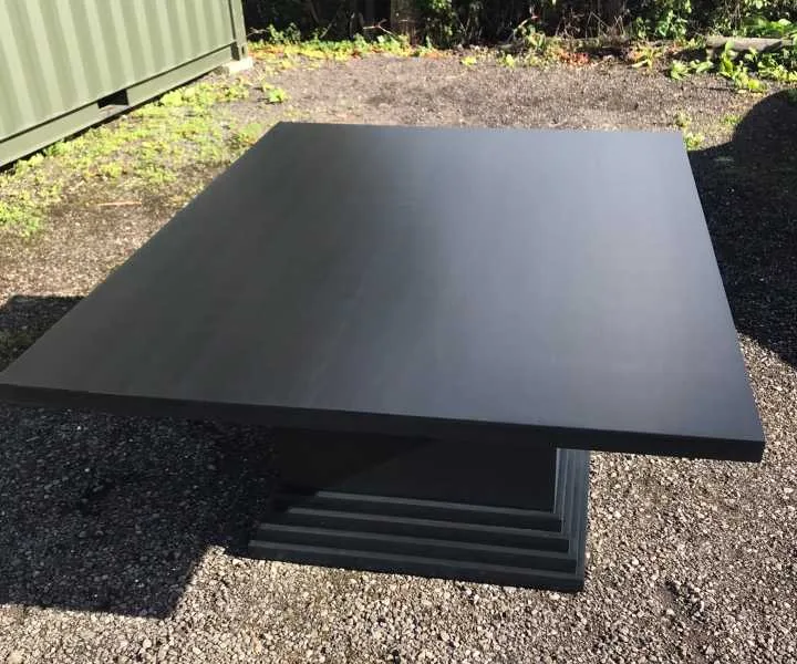 Black painted table waits delivery