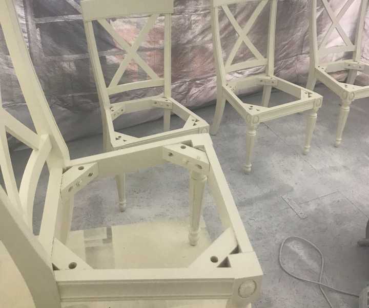 Cream-painted chairs in the spray tent